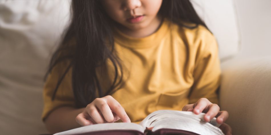 Child reading Bible