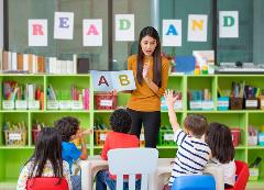 Early Education Teacher with Letters Teaching Children